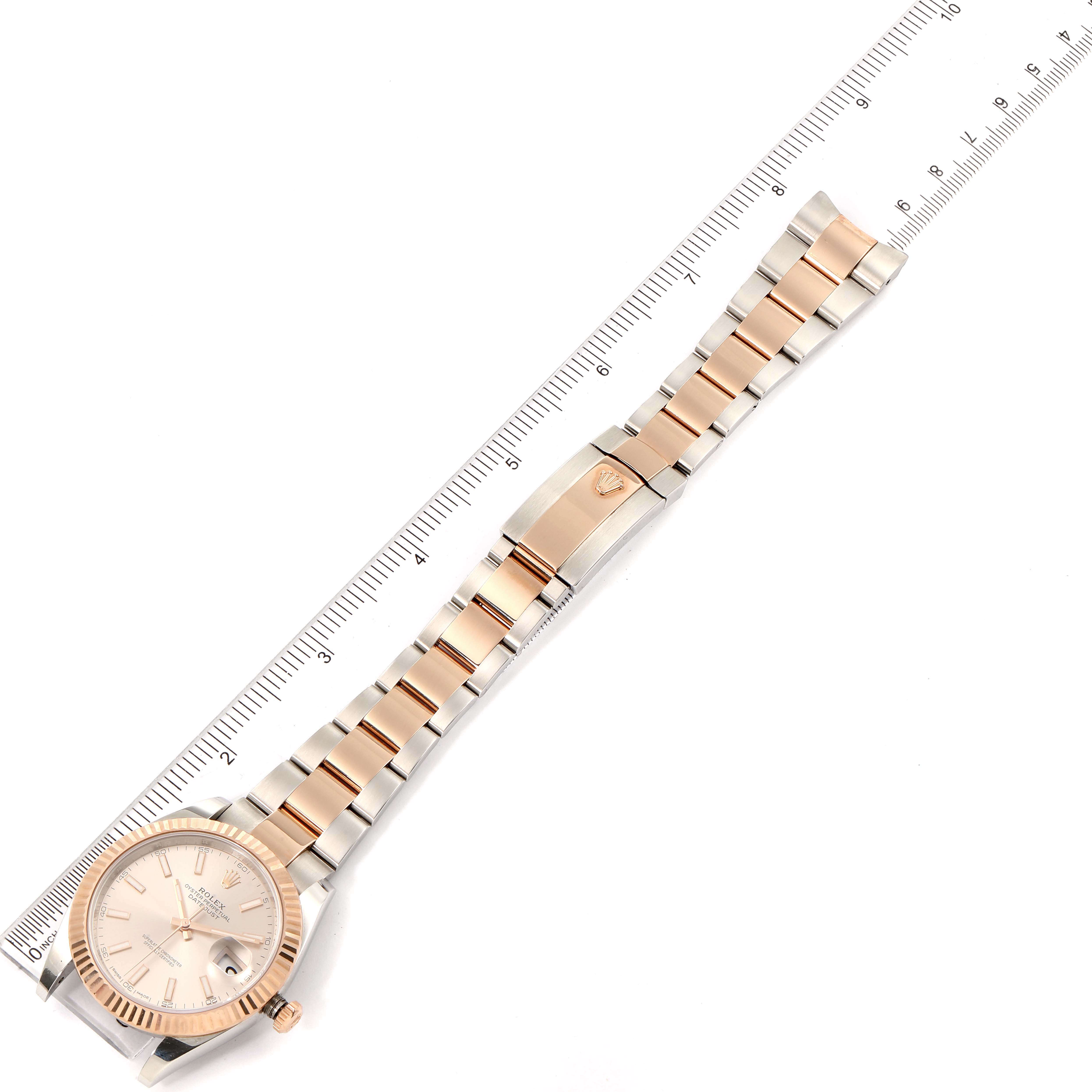 The image shows a top-down view of a Rolex Datejust 41 126331 Men's Steel and Gold (two tone) Beige Dial 126331 Men's Steel and Gold (two tone) Beige Dial watch, including the face, bracelet, and clasp, alongside a ruler for scale.