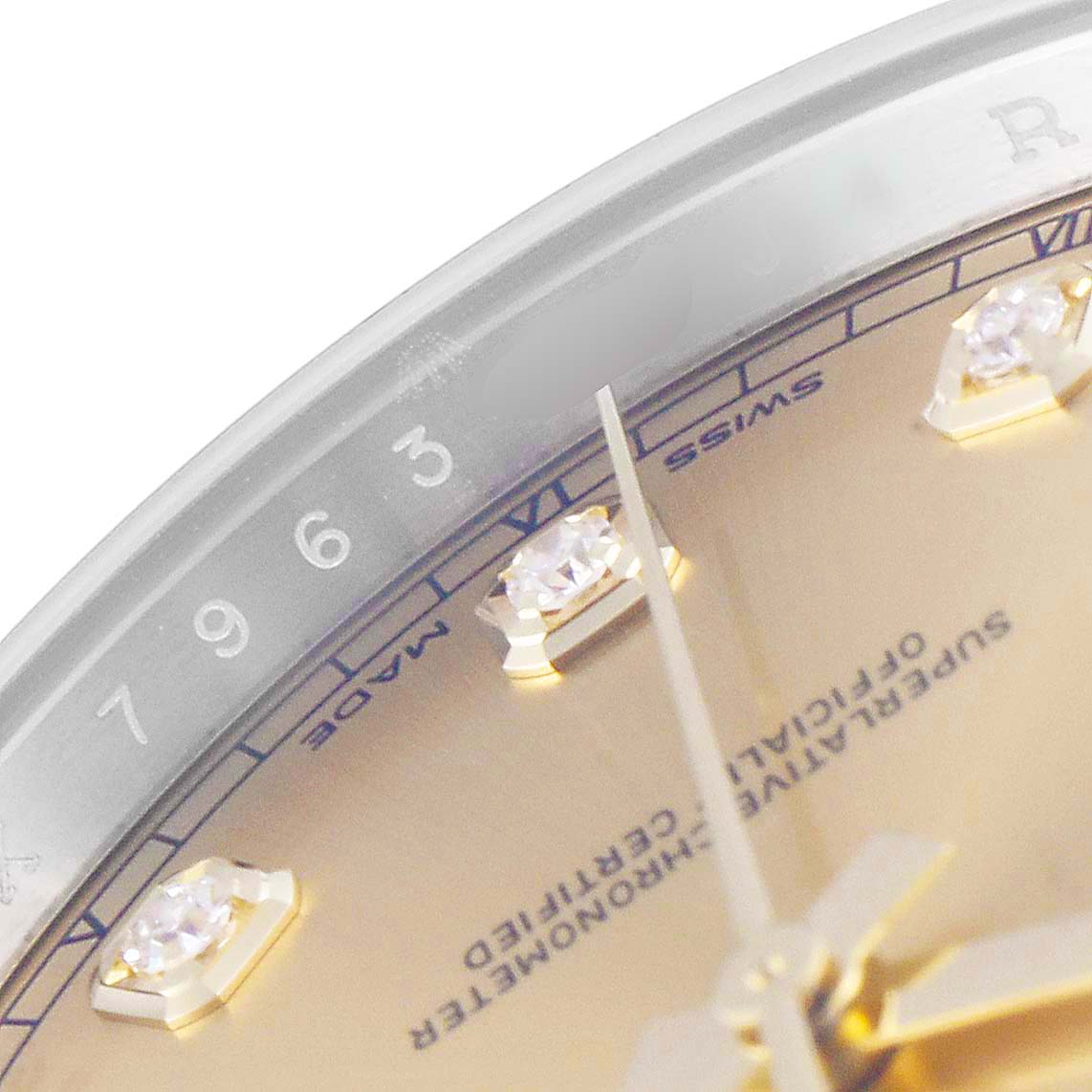 The image shows a zoomed-in view of the dial and bezel of a Rolex Datejust 41 126303 Men's Steel and Gold (two tone) Champagne Dial 126303 Men's Steel and Gold (two tone) Champagne Dial, highlighting the diamond hour markers and part of the seconds hand.