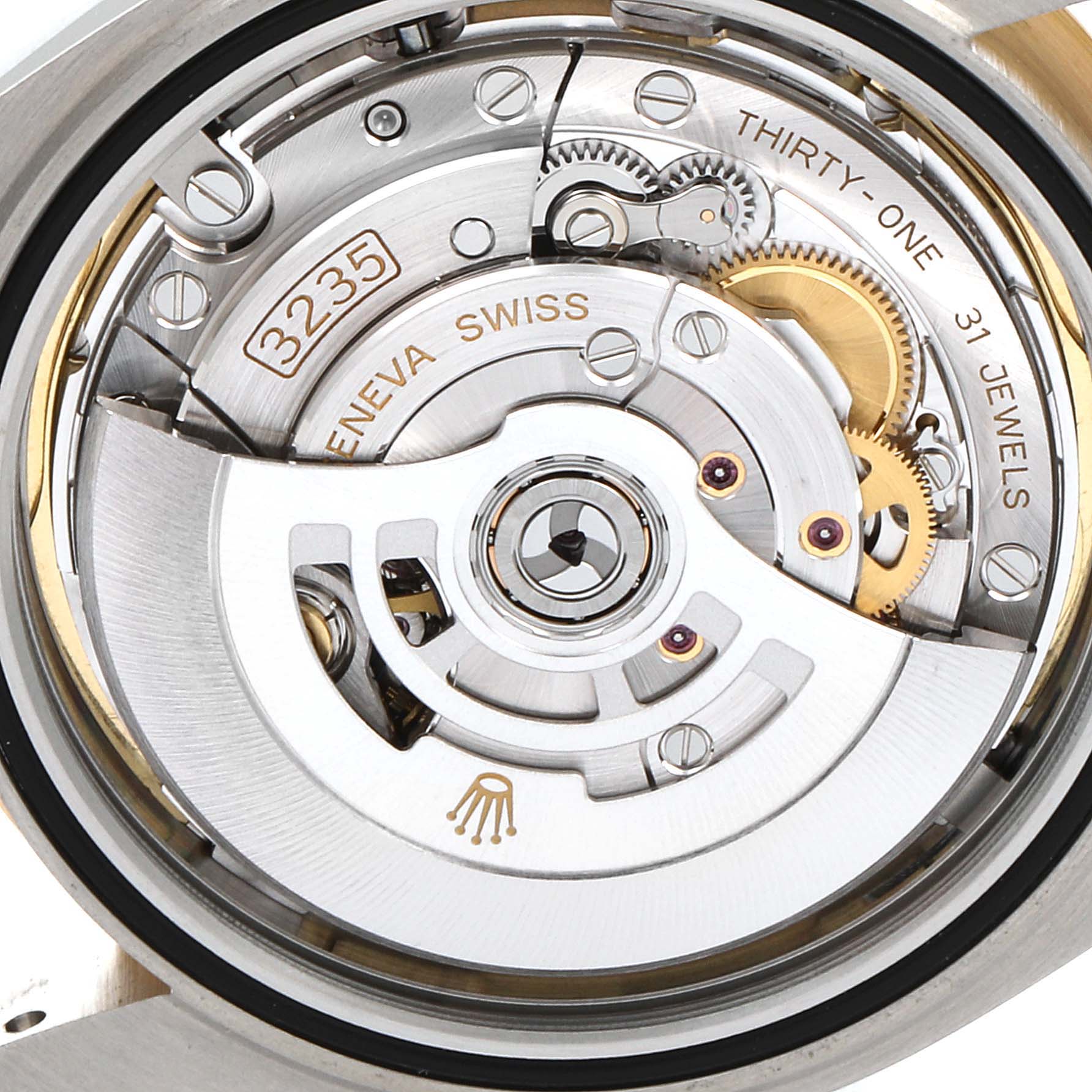 This image shows the movement and internal mechanics of a Rolex Datejust 41 126303 Men's Steel and Gold (two tone) Champagne Dial 126303 Men's Steel and Gold (two tone) Champagne Dial, highlighting the oscillating weight and gear train.
