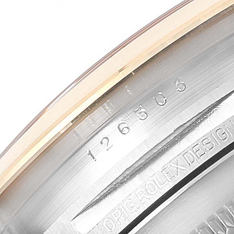 This close-up shows the inner bezel and part of the case with engravings of the Rolex Datejust 41 126303 Men's Steel and Gold (two tone) Champagne Dial 126303 Men's Steel and Gold (two tone) Champagne Dial model.