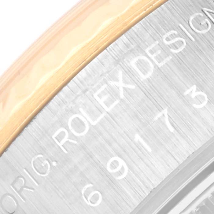 This image shows a close-up of the case side engraving on a Rolex Datejust 69173 Women's Steel and Gold (two tone) Champagne Dial 69173 Women's Steel and Gold (two tone) Champagne Dial watch, featuring part of the model number and brand.