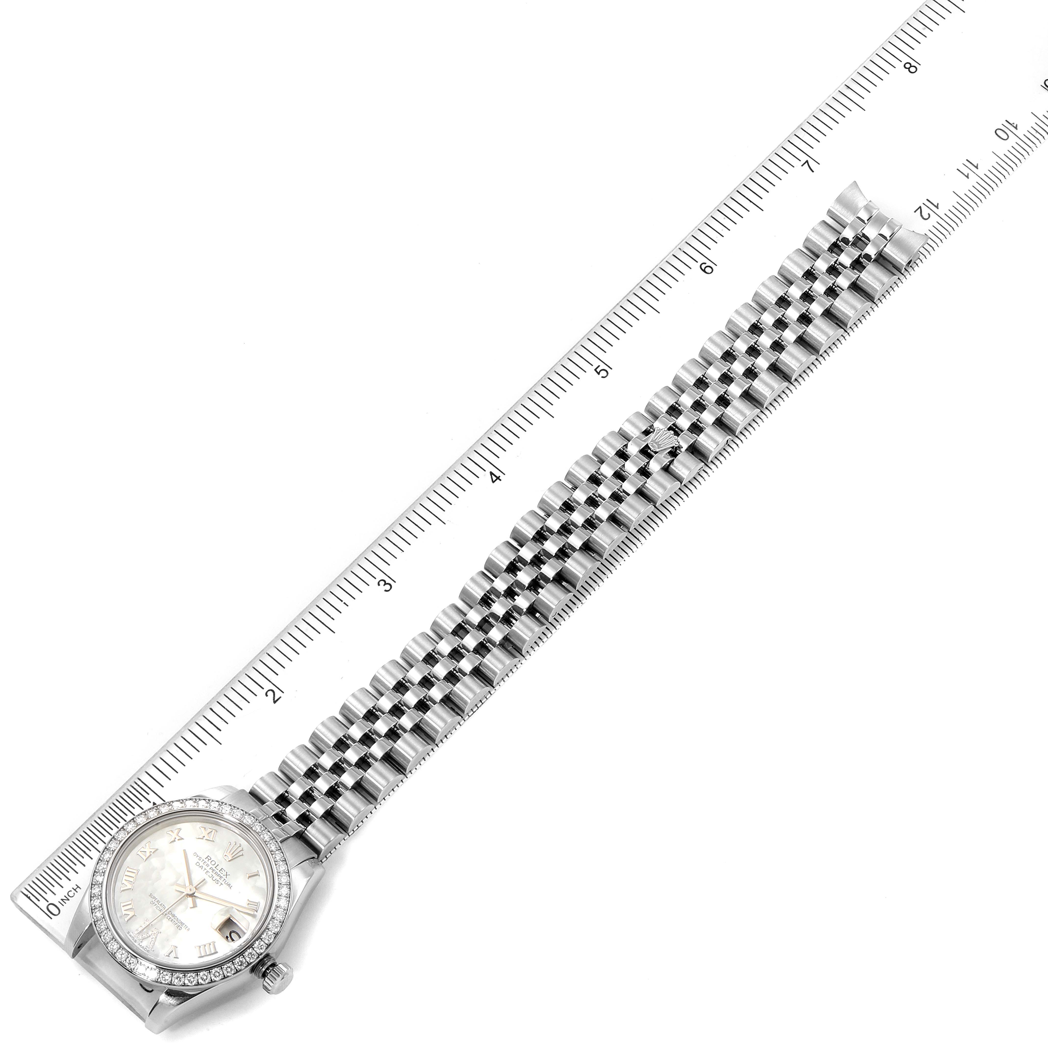 The Rolex Mid-Size 178384 Women
s Stainless Steel Mother of Pearl Dial 178384 Women
s Stainless Steel Mother of Pearl Dial model watch is shown from an overhead angle, displaying the face, bezel, and full bracelet next to a ruler.
