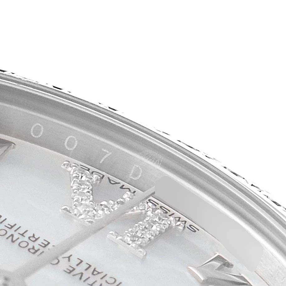 Close-up shot of the dial and bezel of the Rolex Mid-Size 178384 Women
s Stainless Steel Mother of Pearl Dial 178384 Women
s Stainless Steel Mother of Pearl Dial model watch, focusing on the Roman numeral and part of the serial number.
