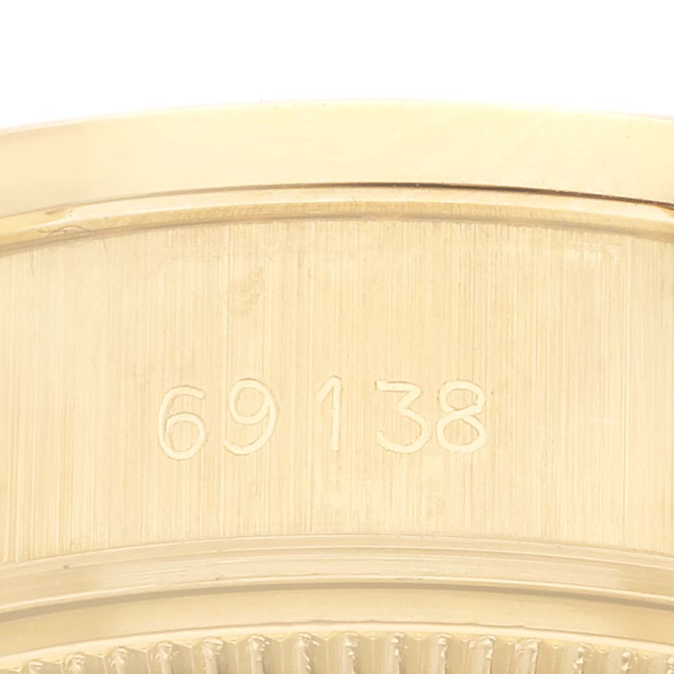 This image shows a close-up of the engraved case back of a President model by Rolex.