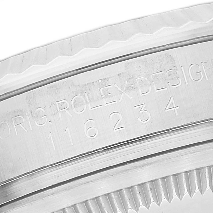 This image shows a close-up view of the serial number engraving on the case back of a Rolex Datejust 116234 Men's Stainless Steel Black Dial 116234 Men's Stainless Steel Black Dial watch.