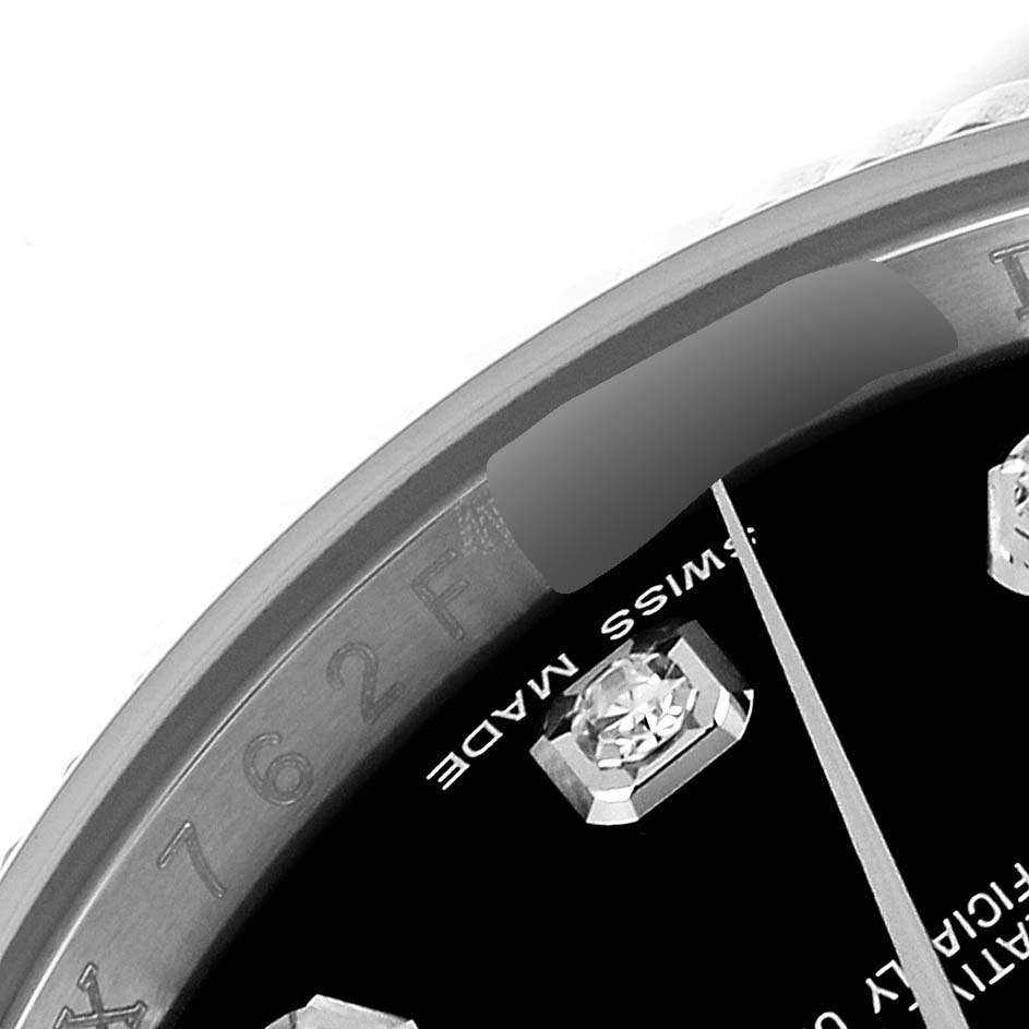 This close-up image of the Rolex Datejust 116234 Men's Stainless Steel Black Dial 116234 Men's Stainless Steel Black Dial watch shows part of the dial, indices, and inner bezel with the serial number engraving.