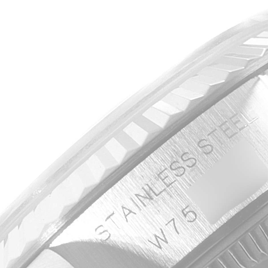 The image shows a close-up angle of the Rolex Datejust 69174 Women
s Stainless Steel Silver Dial 69174 Women
s Stainless Steel Silver Dial
s bezel and part of the stainless steel case.