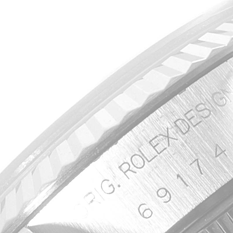 The image shows a partial close-up of the case back and fluted bezel of a Rolex Datejust 69174 Women
s Stainless Steel Silver Dial 69174 Women
s Stainless Steel Silver Dial watch.