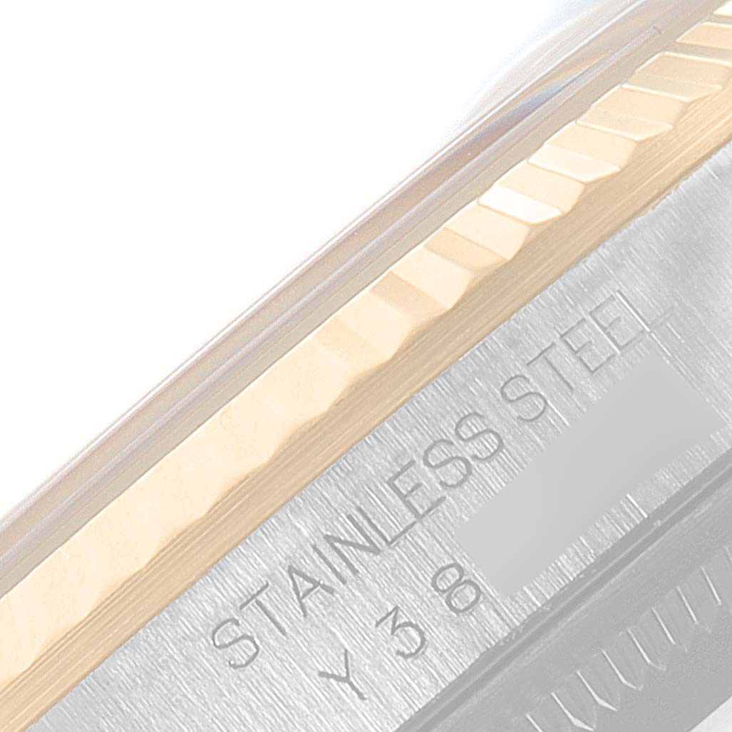 This image shows a close-up of the Rolex Datejust 16233 Men's Steel and Gold (two tone) Champagne Dial 16233 Men's Steel and Gold (two tone) Champagne Dial model, focusing on the stainless steel bezel and part of the engraved text.