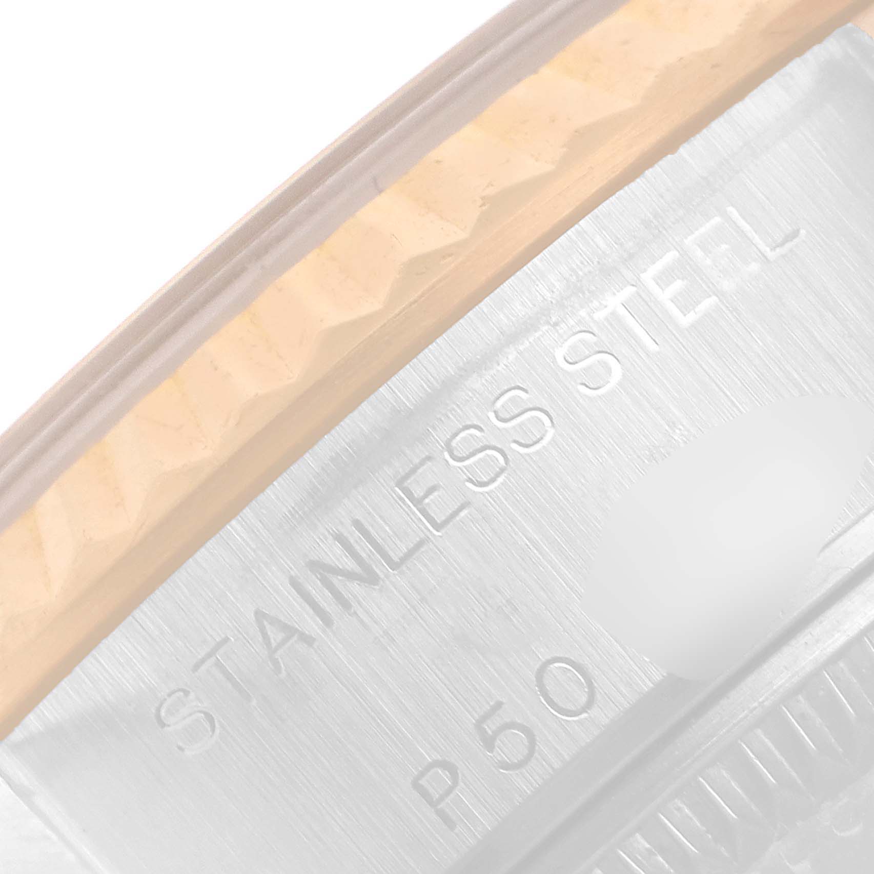 The image shows a close-up of the case and bezel of a Rolex Datejust 79173 Women
s Steel and Gold (two tone) Champagne Dial 79173 Women
s Steel and Gold (two tone) Champagne Dial watch, highlighting the "STAINLESS STEEL" engraving.