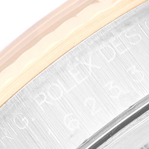 The image shows a close-up of the Rolex Datejust 16233 Men's Steel and Gold (two tone) Blue Dial 16233 Men's Steel and Gold (two tone) Blue Dial model's metal bezel and engraved lettering.