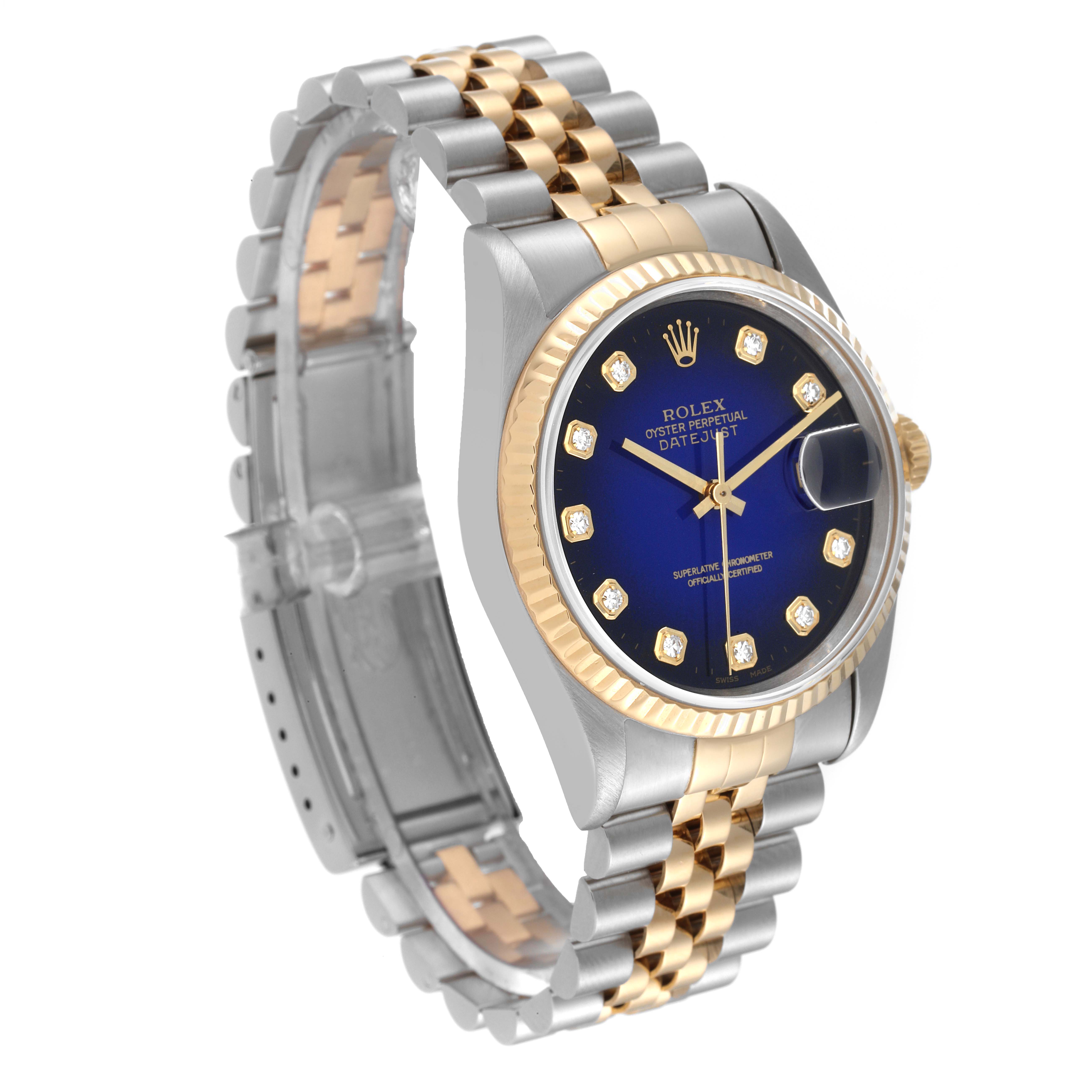 The image shows a Rolex Datejust 16233 Men's Steel and Gold (two tone) Blue Dial 16233 Men's Steel and Gold (two tone) Blue Dial watch at an angled view highlighting the blue dial, fluted bezel, and two-tone bracelet.