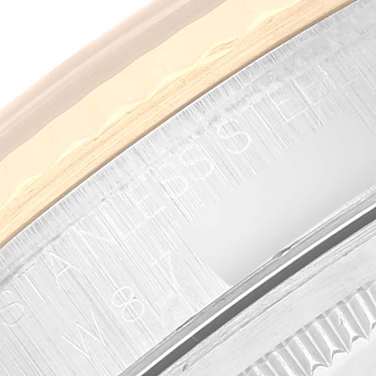 This image shows a close-up of the side of the bezel and case back of a Rolex Datejust 16233 Men's Steel and Gold (two tone) Blue Dial 16233 Men's Steel and Gold (two tone) Blue Dial watch.