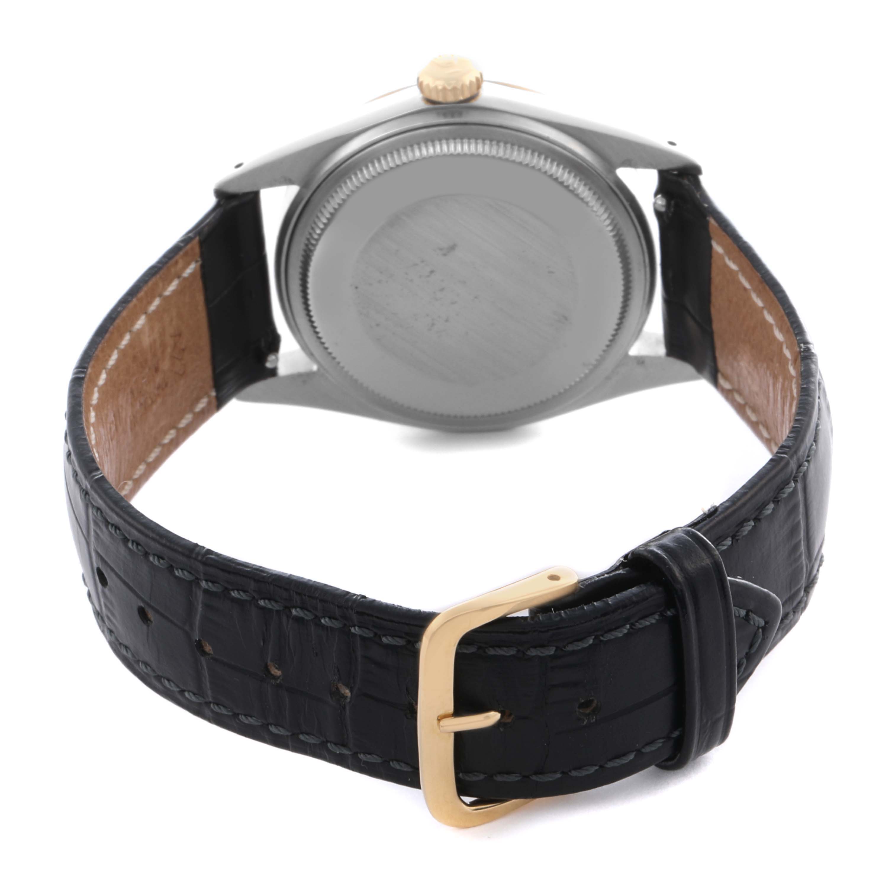 The image shows the back case and clasp of the Rolex Datejust 16013 Men's Steel and Gold (two tone) White Dial 16013 Men's Steel and Gold (two tone) White Dial watch with a black leather strap and gold buckle.