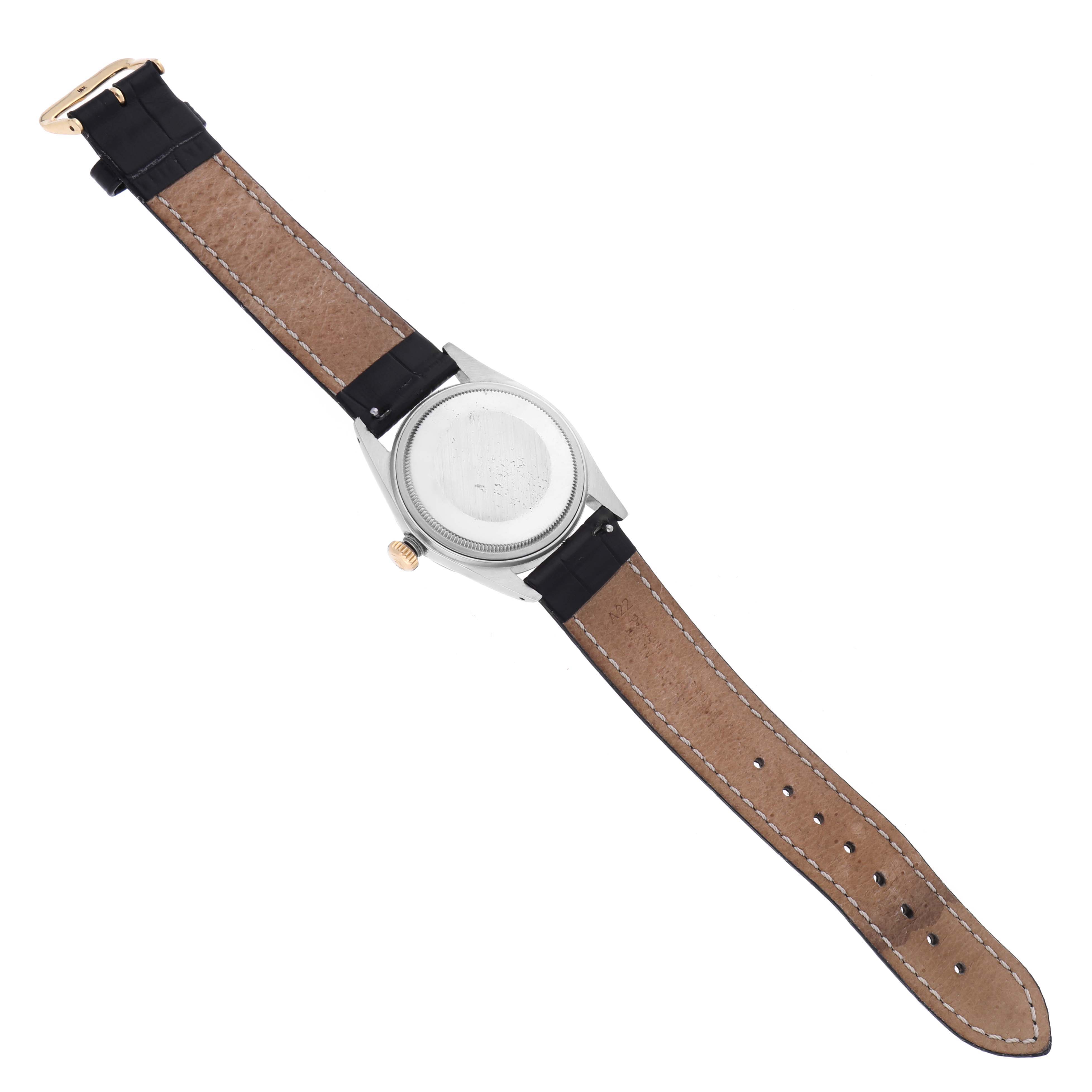 The Rolex Datejust 16013 Men's Steel and Gold (two tone) White Dial 16013 Men's Steel and Gold (two tone) White Dial watch is shown from the back, displaying its case back, crown, and strap.