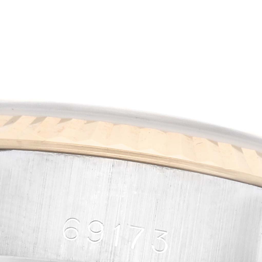 The image shows a close-up of the side of a Rolex Datejust 69173 Women's Steel and Gold (two tone) White Dial 69173 Women's Steel and Gold (two tone) White Dial watch, featuring its fluted bezel and case with model number engraving.