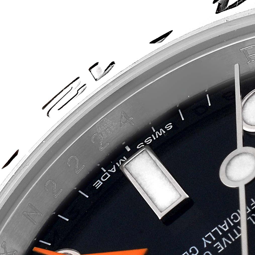 Close-up of the Rolex Explorer 216570 Men's Stainless Steel Black Dial 216570 Men's Stainless Steel Black Dial watch upper dial, showing hour and minute hands, and a partial view of the bezel.