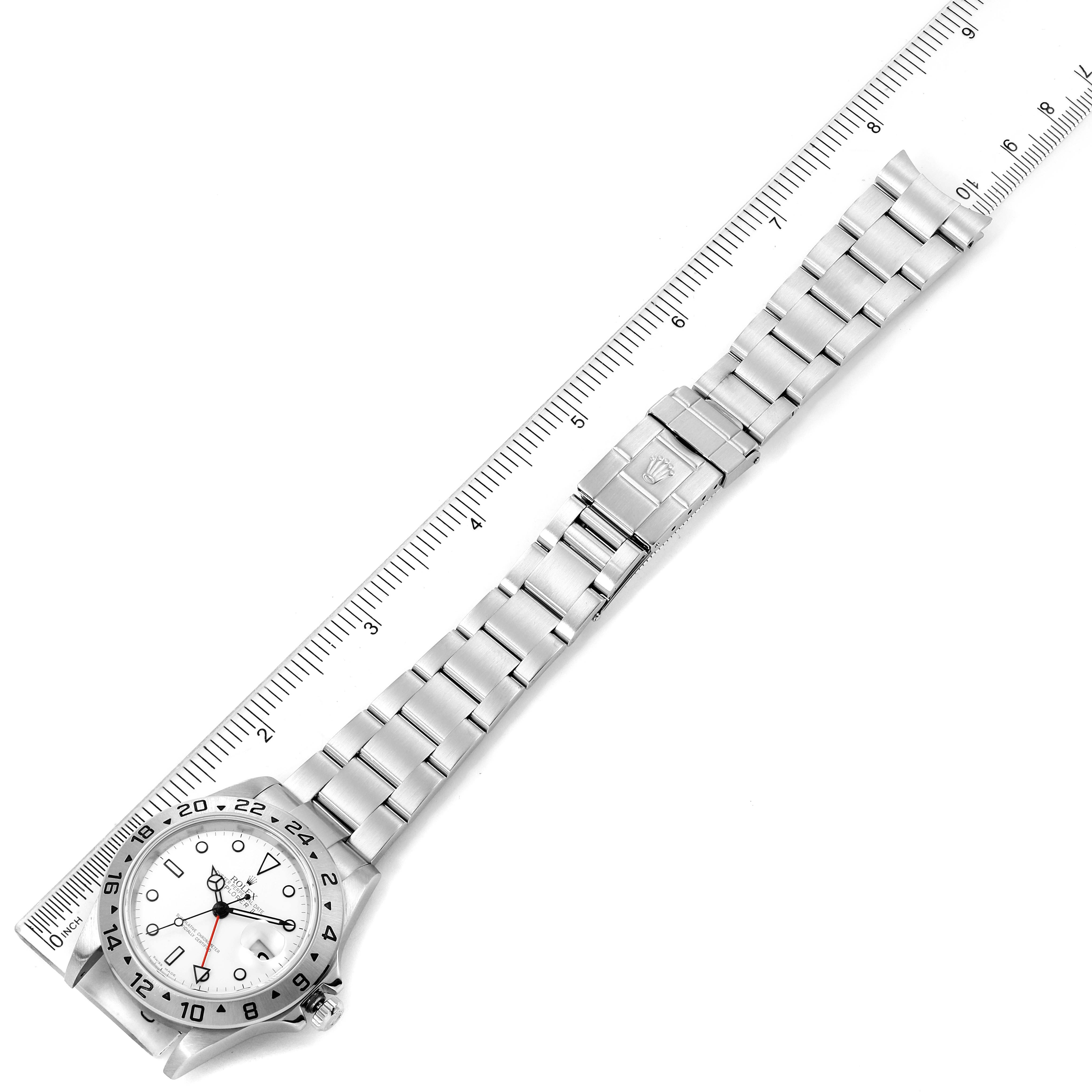This image shows a flat lay of the Rolex Explorer 16570 Men's Stainless Steel White Dial 16570 Men's Stainless Steel White Dial watch, showcasing its entire bracelet and clasp against a ruler.
