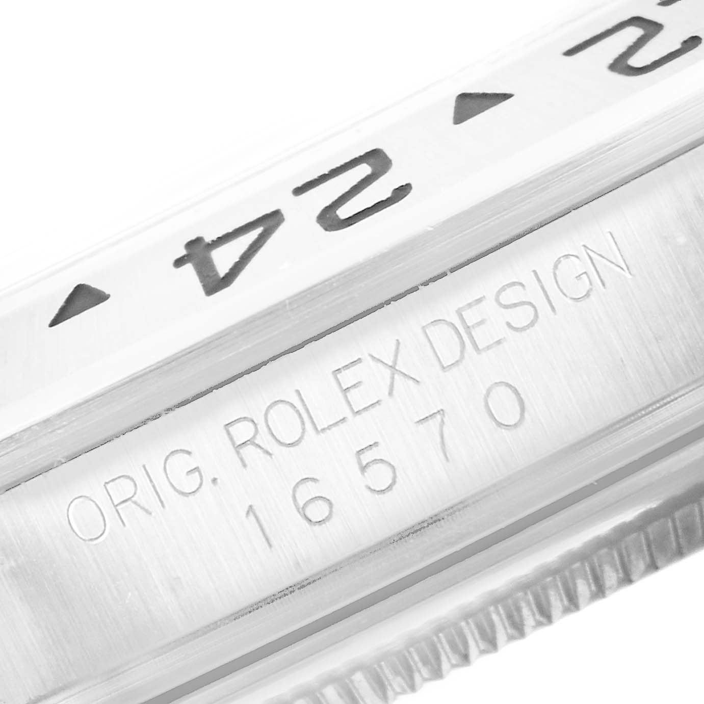 The image shows a close-up of the bezel and engraved serial number of a Rolex Explorer 16570 Men's Stainless Steel White Dial 16570 Men's Stainless Steel White Dial model watch.