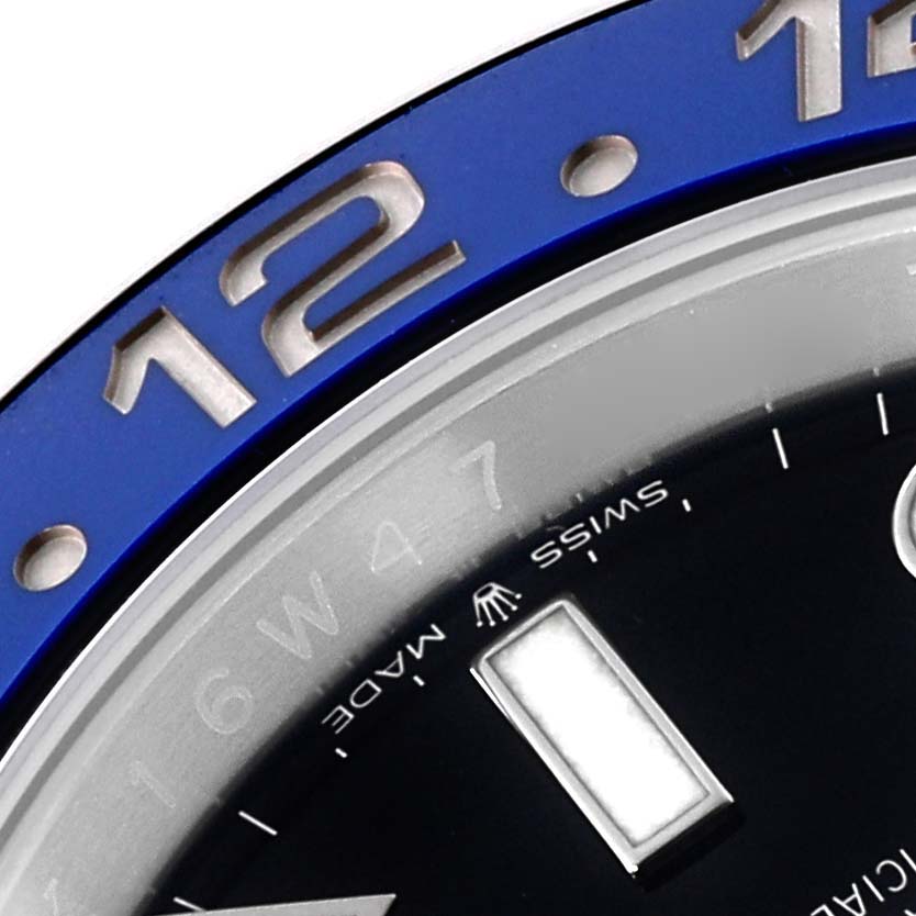 This close-up image of the Rolex GMT-Master 126710BLNR Men
s Stainless Steel Black Dial 126710BLNR Men
s Stainless Steel Black Dial watch shows part of the blue bezel and part of the dial with hour markers.