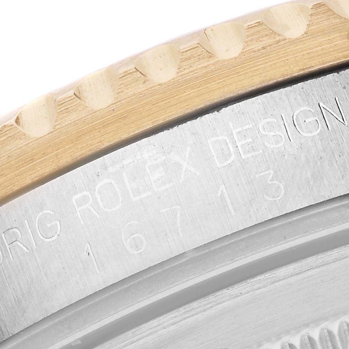 Close-up of the side view of a Rolex GMT-Master 16713 Men's Steel and Gold (two tone) Black Dial 16713 Men's Steel and Gold (two tone) Black Dial model, showing the bezel and part of the engraved caseback.