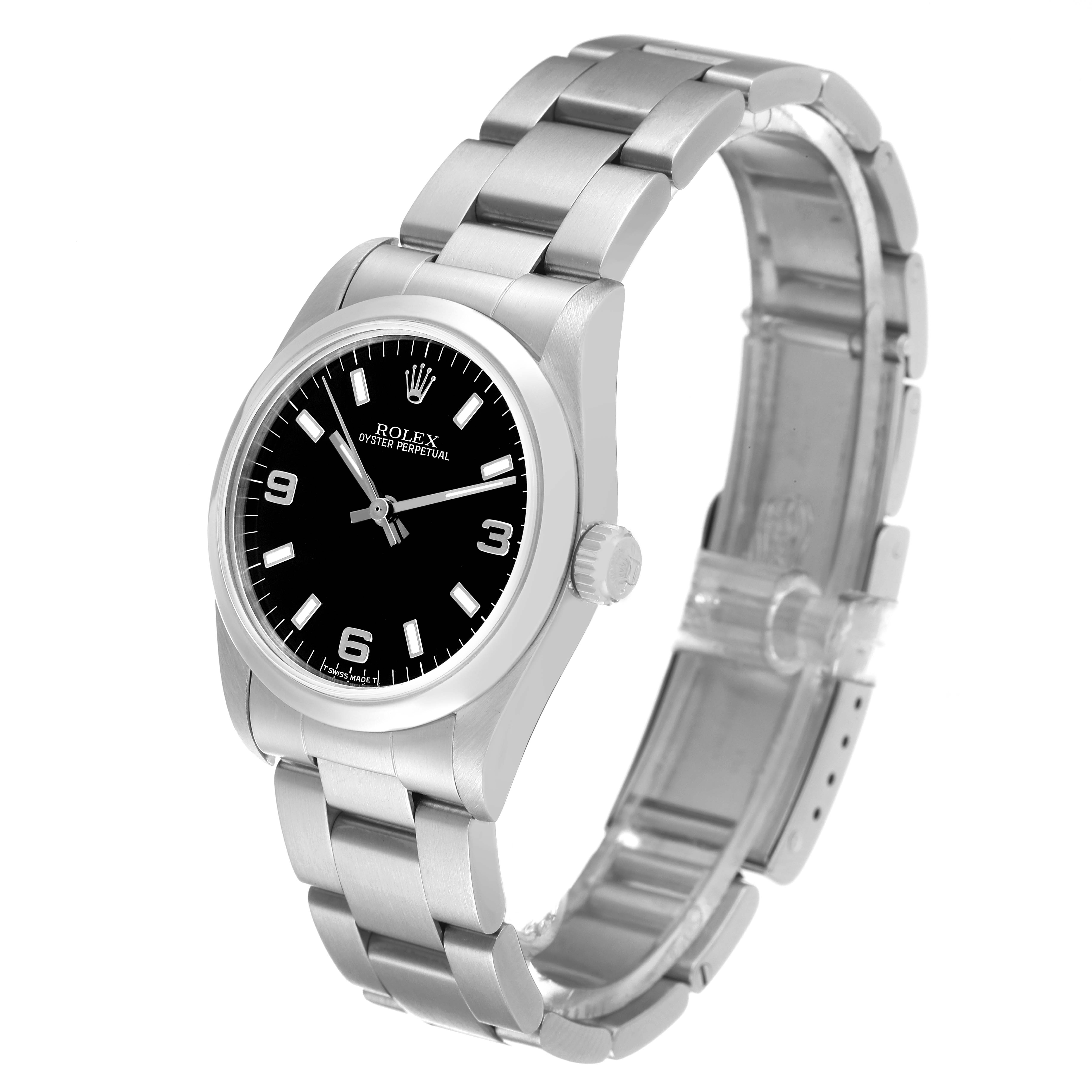 The image shows a Rolex Mid-Size 67480 Women
s Stainless Steel Black Dial 67480 Women
s Stainless Steel Black Dial Oyster Perpetual watch at a three-quarter angle, highlighting the dial, crown, and bracelet.