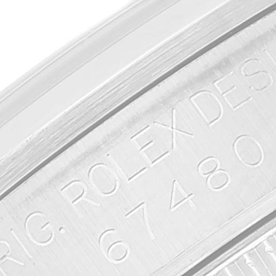 The image shows a close-up of the case side of a Rolex Mid-Size 67480 Women
s Stainless Steel Black Dial 67480 Women
s Stainless Steel Black Dial watch, specifically the engraved model number.