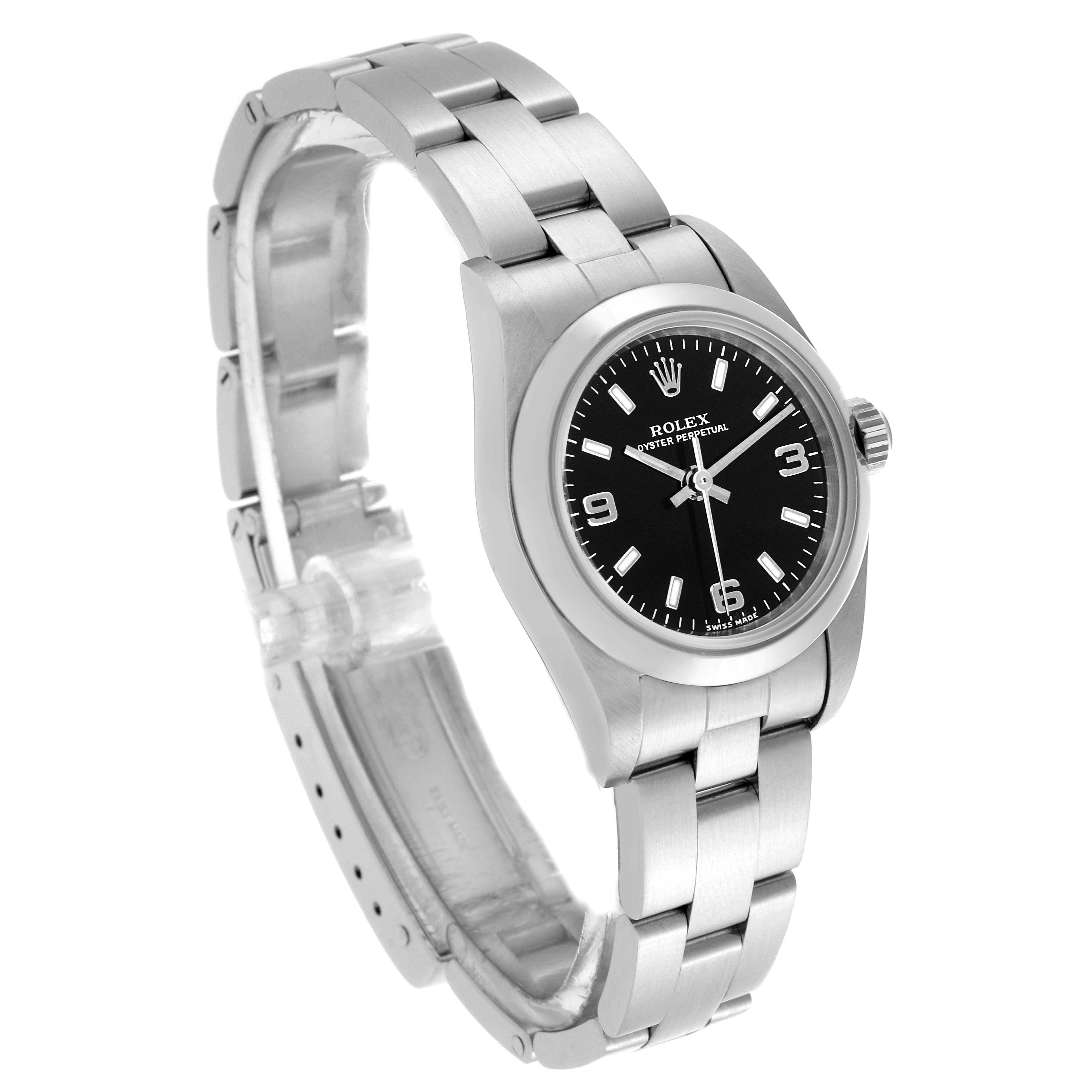 The Rolex Oyster Perpetual 76080 Women's Stainless Steel Black Dial 76080 Women's Stainless Steel Black Dial watch is shown at a tilted angle, displaying its dial, bezel, and partially open bracelet.