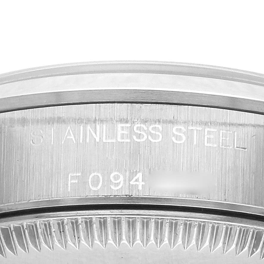 The image shows the side of a Rolex Oyster Perpetual 76080 Women's Stainless Steel Black Dial 76080 Women's Stainless Steel Black Dial watch case, highlighting its stainless steel material and engraved details.