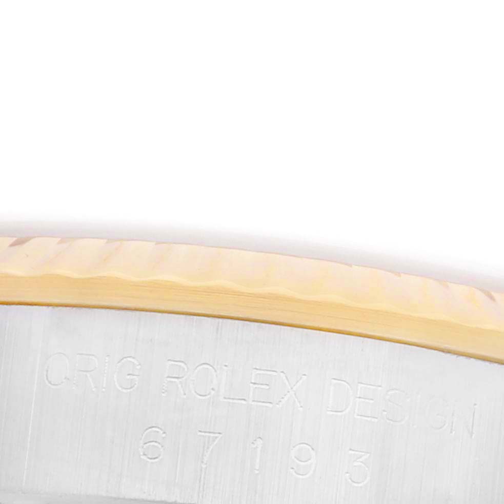 This image shows a close-up of the engraved side of the Rolex Oyster Perpetual 67193 Women's Steel and Gold (two tone) Champagne Dial 67193 Women's Steel and Gold (two tone) Champagne Dial watch case, highlighting the "ORIG ROLEX DESIGN" text.
