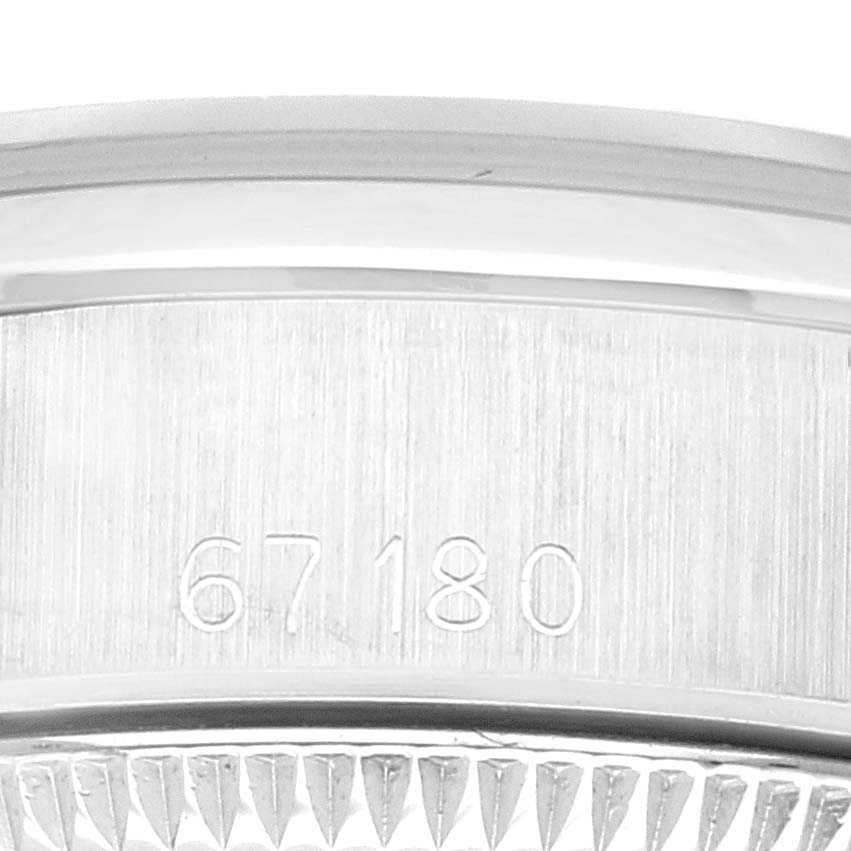 The image shows a close-up of the side of the Rolex Oyster Perpetual 67180 Women's Stainless Steel Silver Dial 67180 Women's Stainless Steel Silver Dial watch case with the model number 67180 engraved.