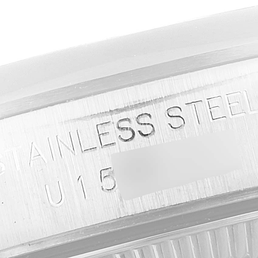 This image shows a close-up of the case back and engraved serial number of a Rolex Oyster Perpetual 67180 Women's Stainless Steel Pink Dial 67180 Women's Stainless Steel Pink Dial watch.