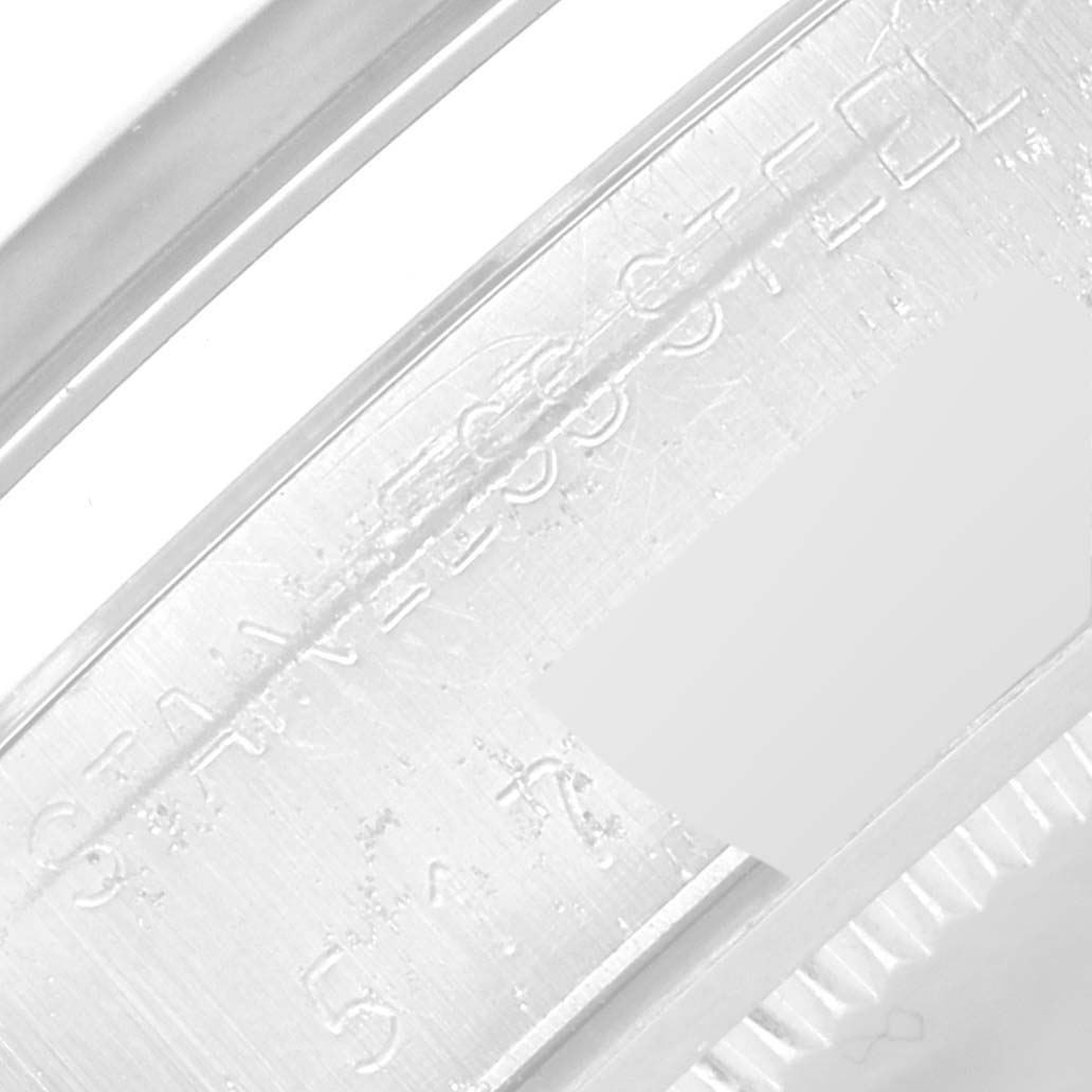 This image shows an up-close view of the metal case side of a Vintage Collection Rolex watch.