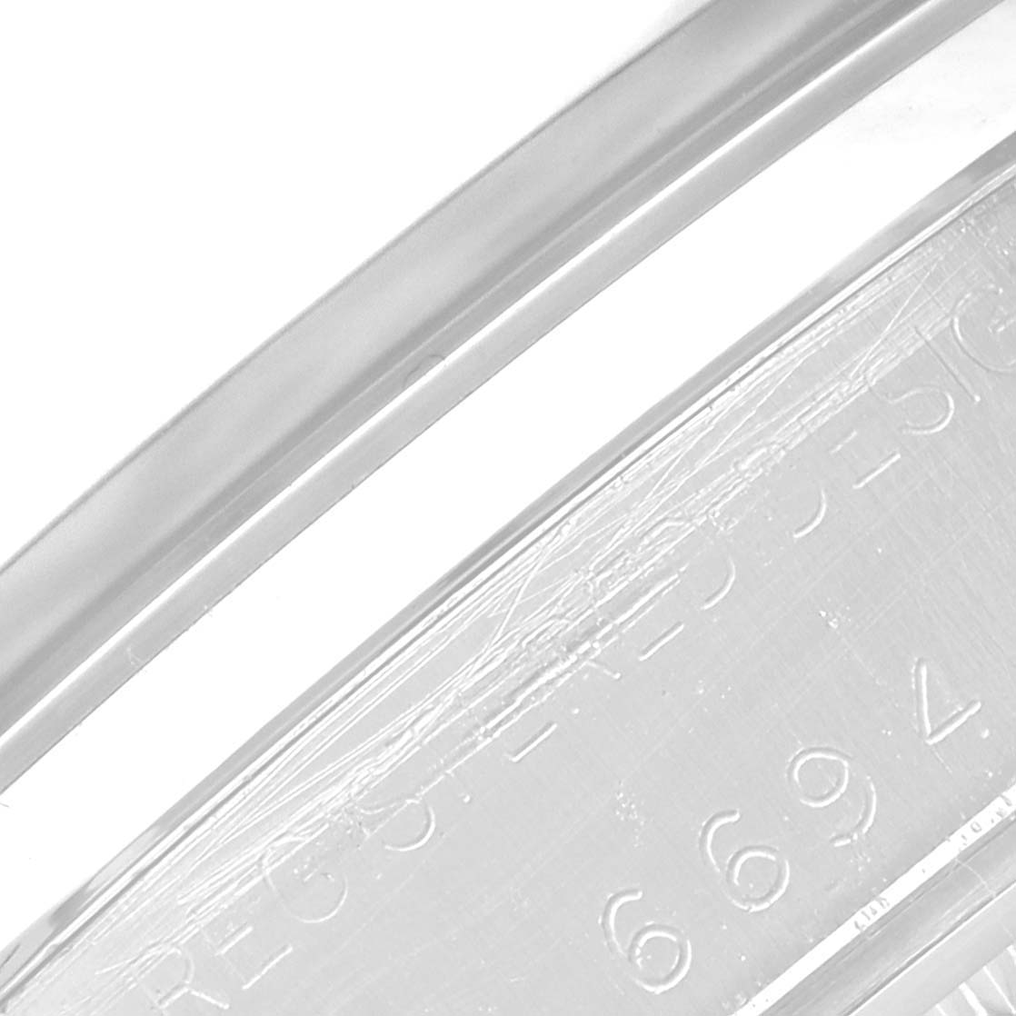 This image shows a close-up view of the inner bezel and some engraved text of the Rolex Vintage Collection 6694 Men's Stainless Steel Black Dial 6694 Men's Stainless Steel Black Dial model watch.