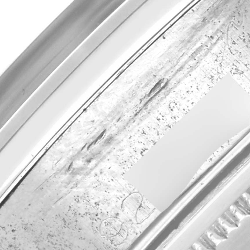 The image shows a close-up of the outer bezel edge of a Rolex Date 6694 Men's Stainless Steel Black Dial 6694 Men's Stainless Steel Black Dial watch, highlighting the metal texture.