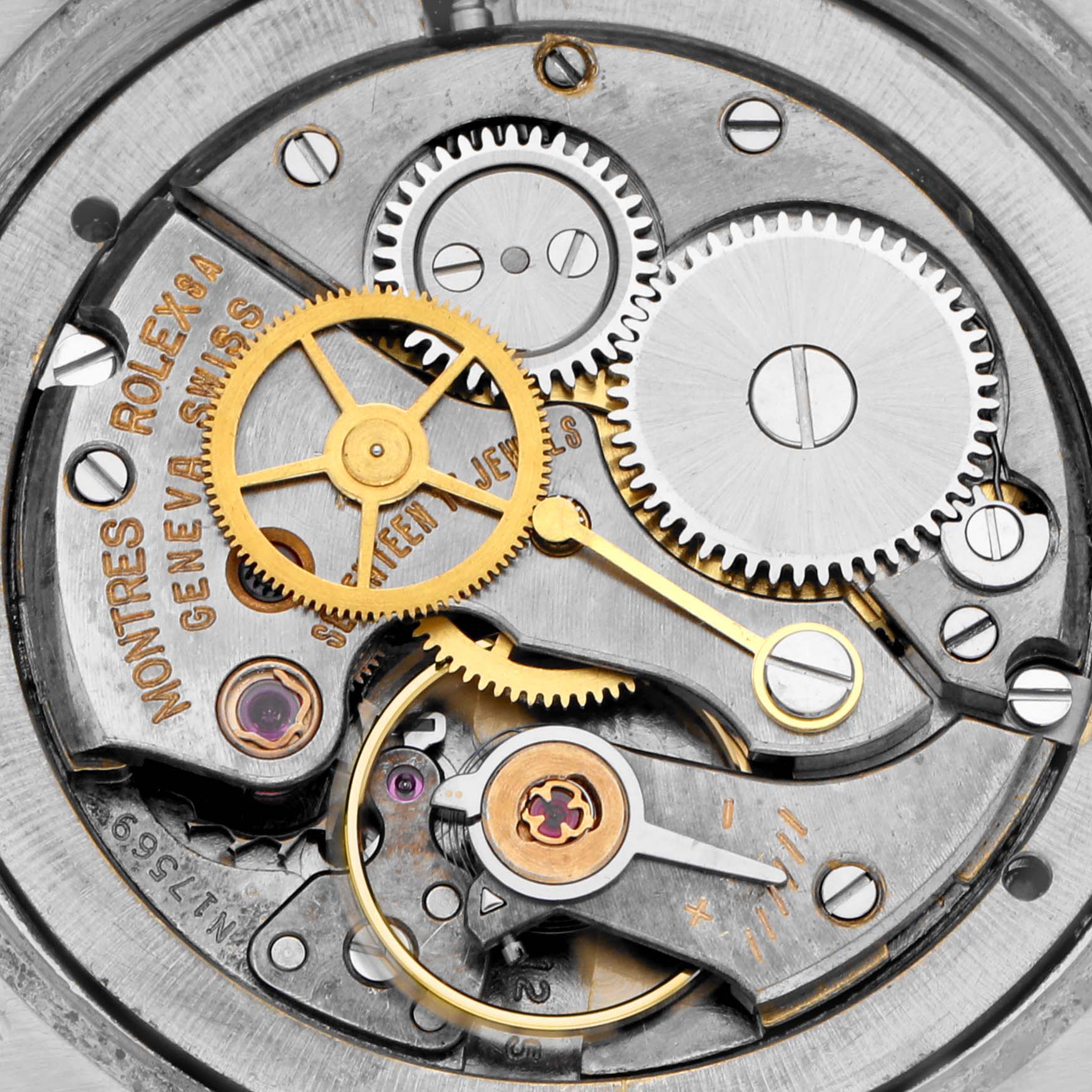 The image shows the inner mechanics of a Rolex Date 6694 Men's Stainless Steel Black Dial 6694 Men's Stainless Steel Black Dial watch, featuring gears and jewels.