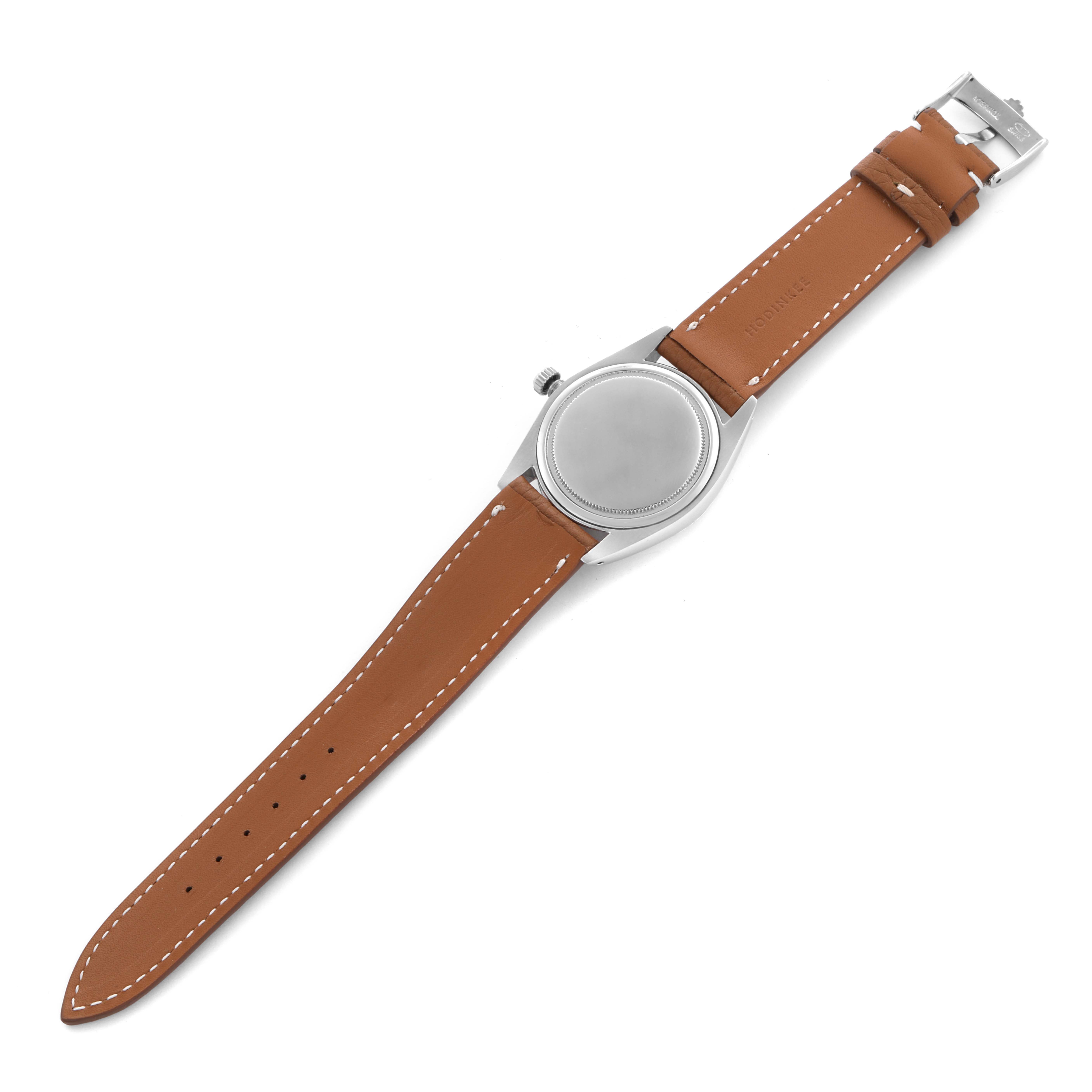 The Rolex Date 6694 Men's Stainless Steel Black Dial 6694 Men's Stainless Steel Black Dial model watch is shown from the back, featuring the case back, crown, and brown leather strap with a buckle.