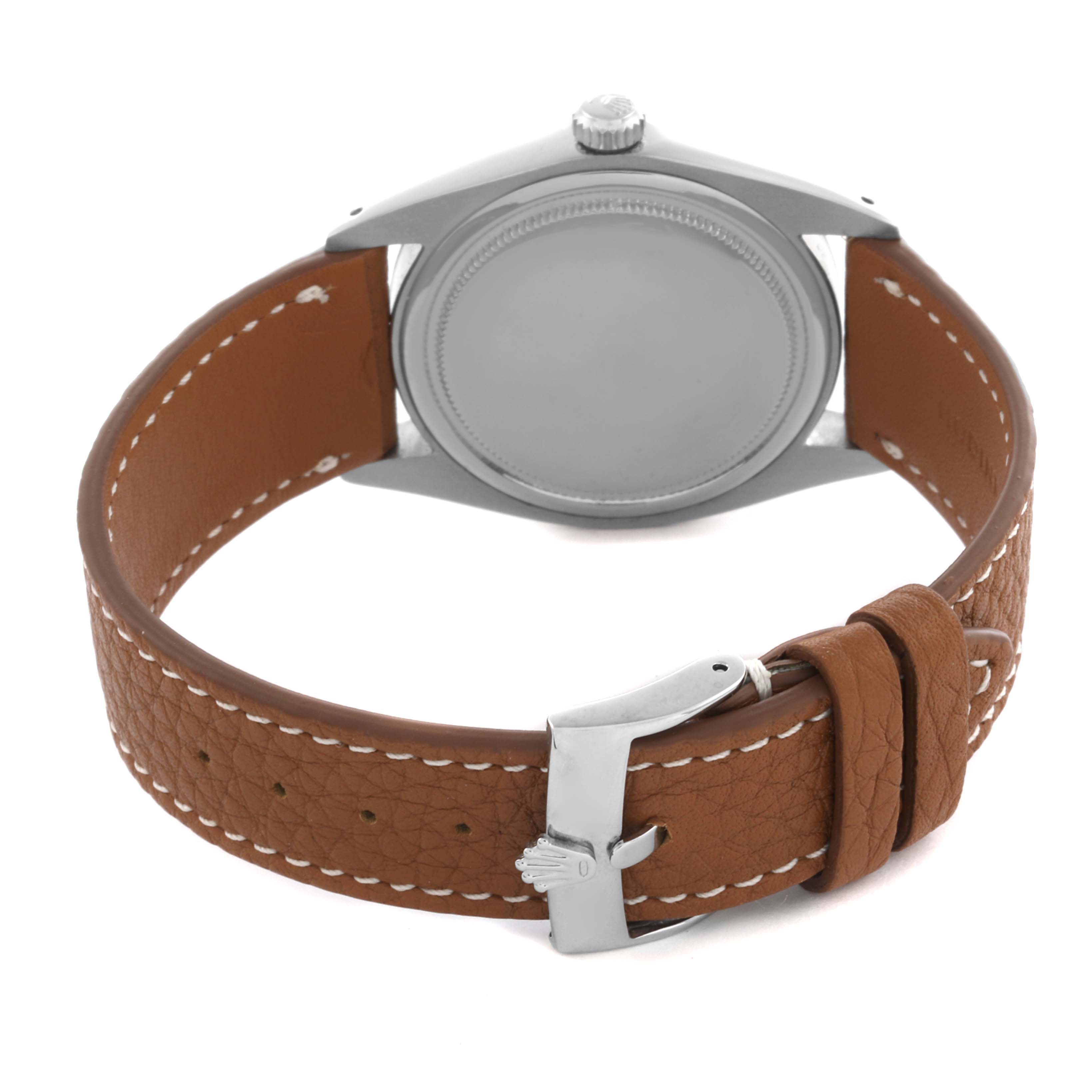 The Rolex Date 6694 Men's Stainless Steel Black Dial 6694 Men's Stainless Steel Black Dial watch is shown from the back, highlighting the case, crown, and brown leather strap with stitching.