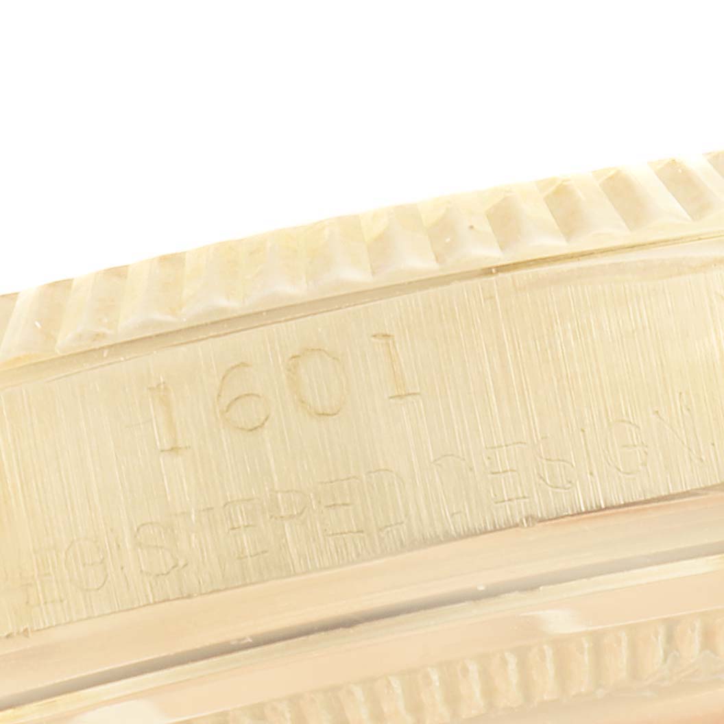 The image shows a close-up angle of the side engraving on the case of a Rolex Vintage Collection 1601 Men's Yellow Gold Black Dial 1601 Men's Yellow Gold Black Dial model 1601 watch.