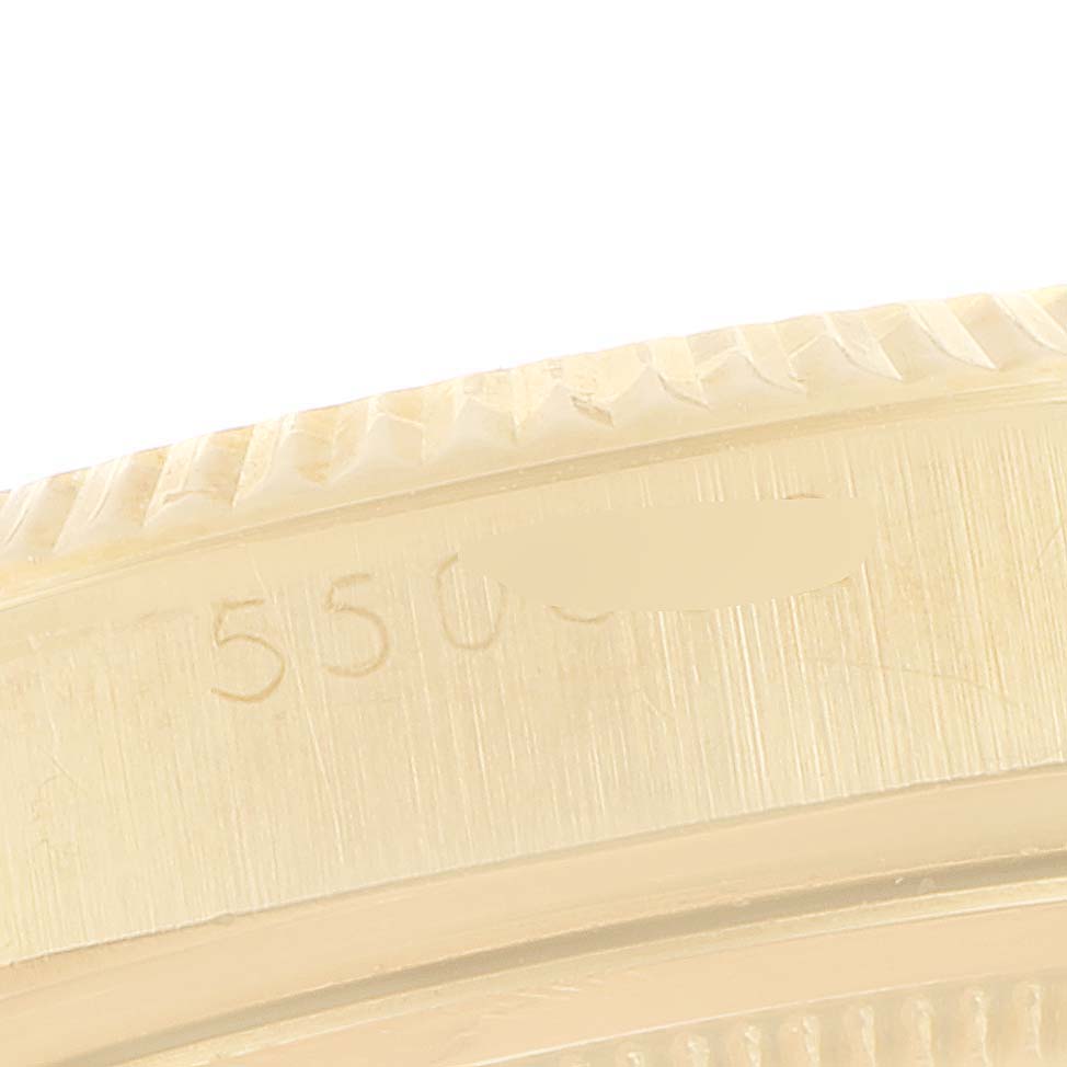This image shows a close-up of the bezel and case side, featuring engravings, on a Vintage Collection model by Rolex.