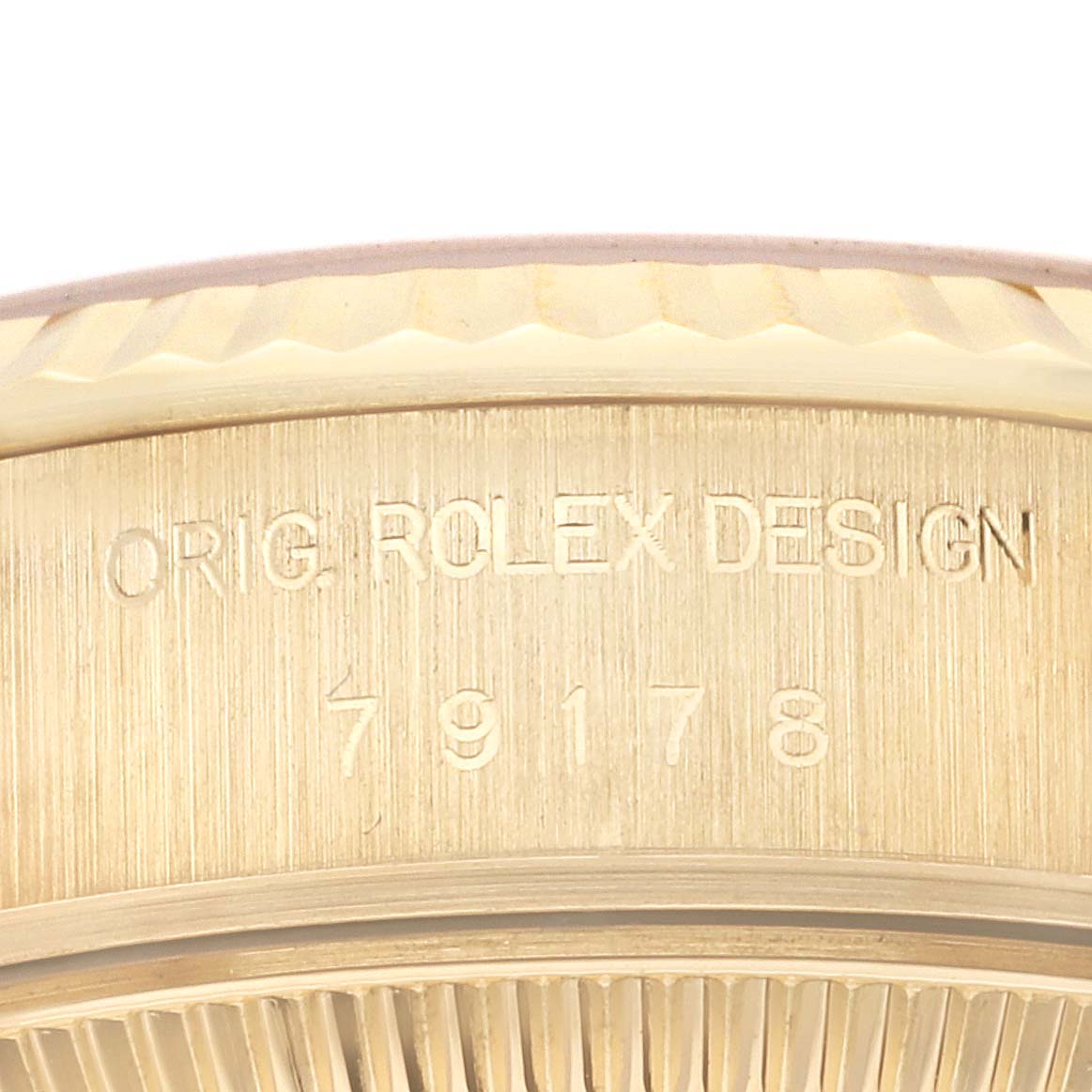 This is a close-up angle of the Rolex President 79178 Women's Yellow Gold Silver Dial 79178 Women's Yellow Gold Silver Dial model watch, showing the engraved text on the case.