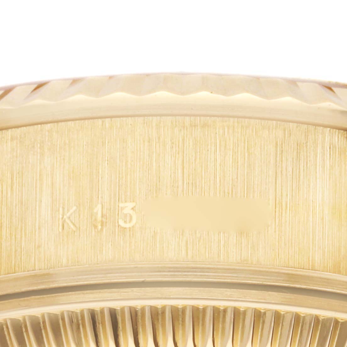This close-up image of the Rolex President 79178 Women's Yellow Gold Silver Dial 79178 Women's Yellow Gold Silver Dial model shows the side of the case with part of the serial number.