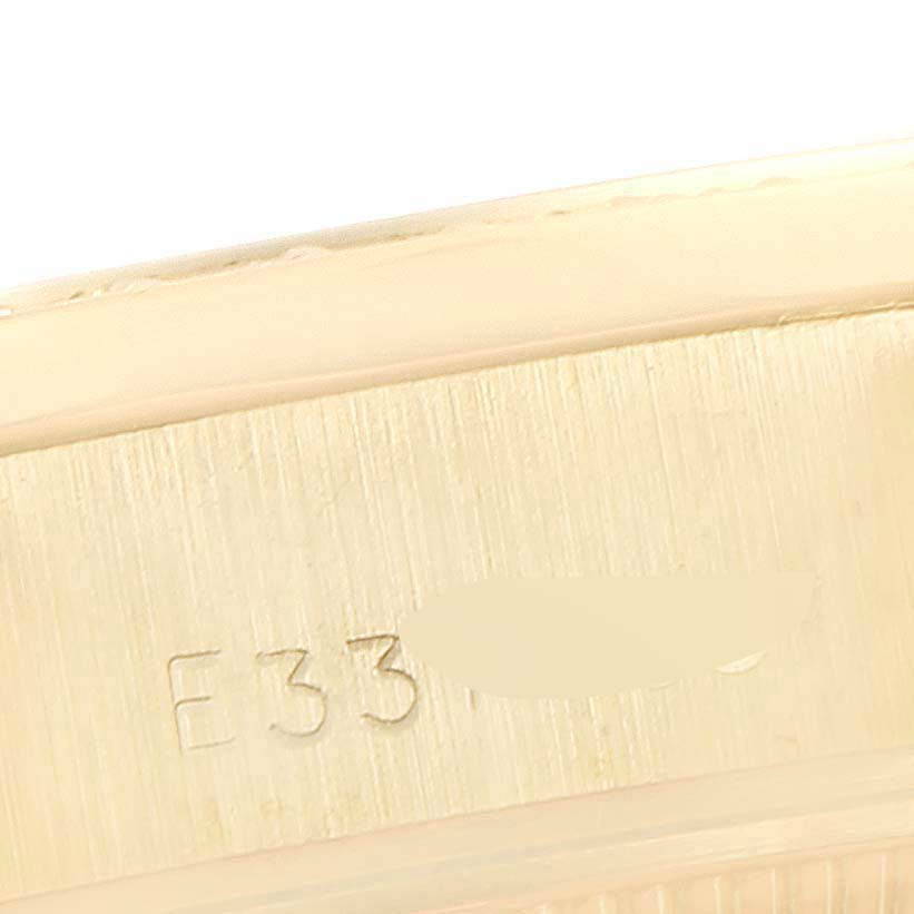 The image shows the edge and part of the case back of a Rolex President 69138 Women's Yellow Gold  69138 Women's Yellow Gold  model watch.