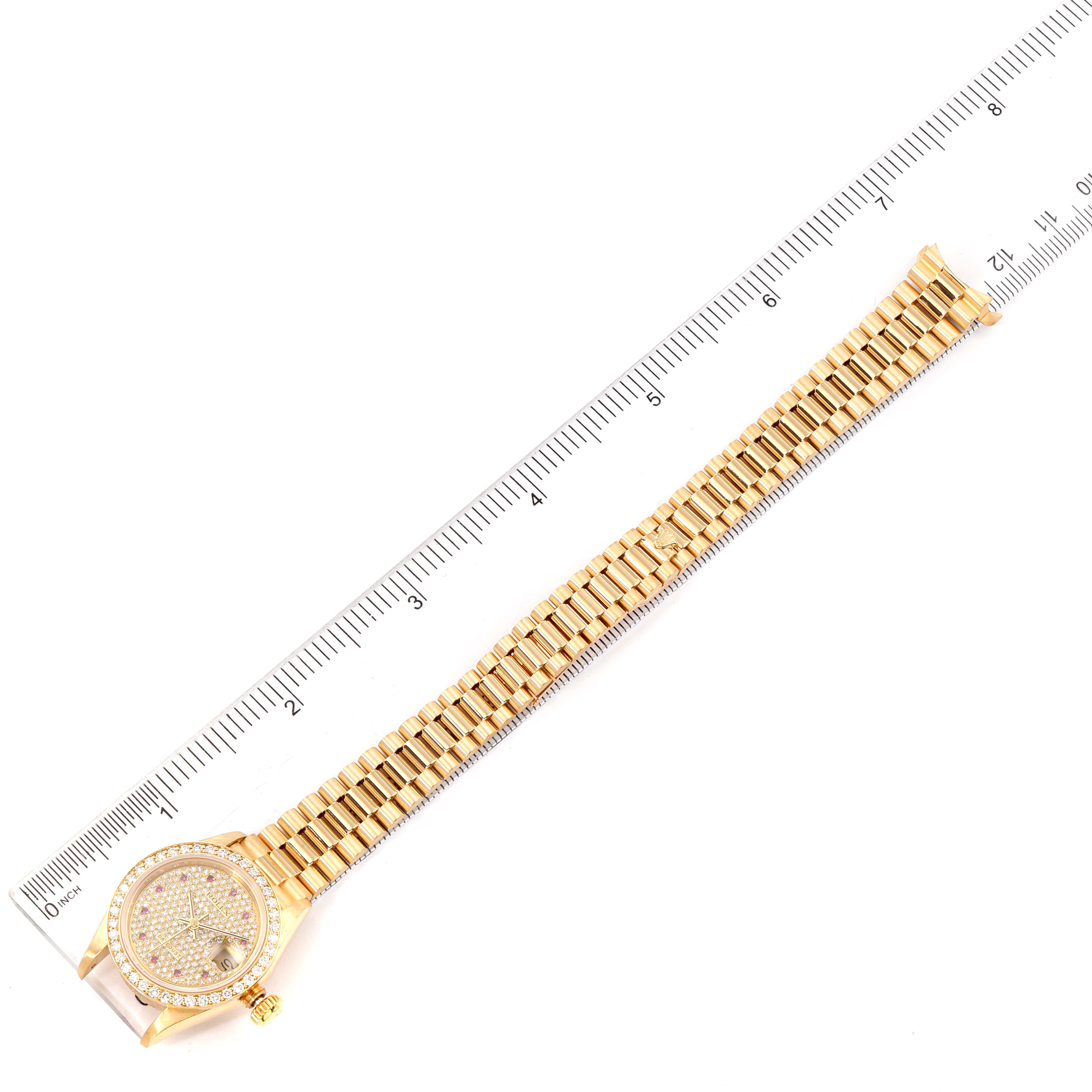 The image shows a top-down view of a gold Rolex President 69138 Women's Yellow Gold  69138 Women's Yellow Gold  watch with a ruler for size reference.