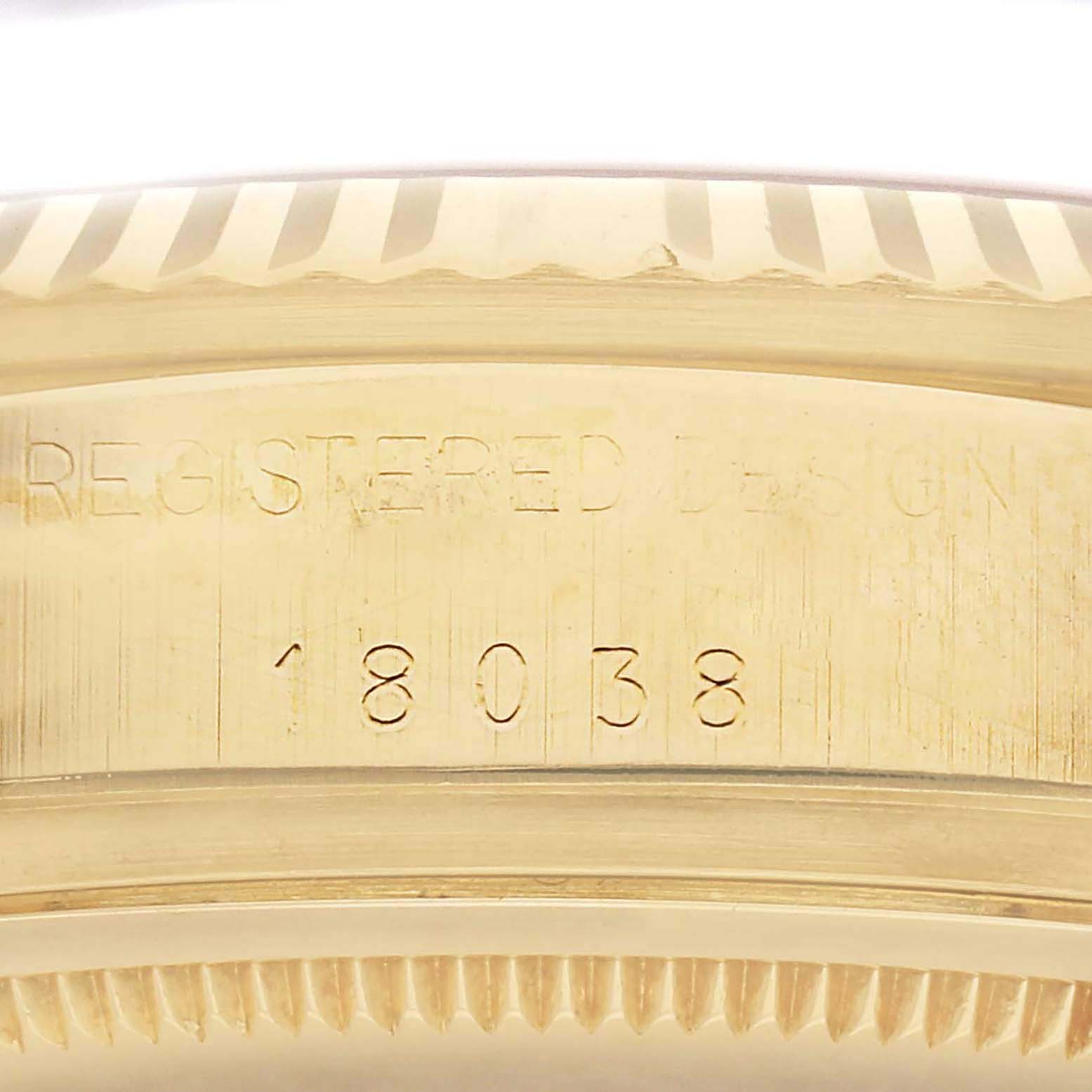 The image shows a close-up of the Rolex President 18038 Men's Yellow Gold Champagne Dial 18038 Men's Yellow Gold Champagne Dial model's gold bezel with engraved design number 18038.