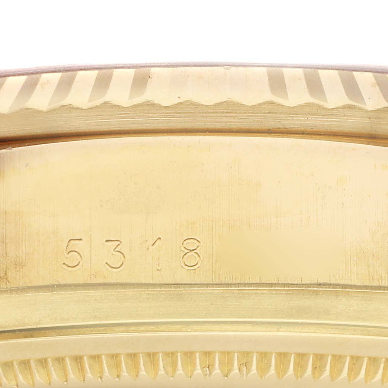The image shows a close-up of the gold bezel and case edge of a Rolex President 18038 Men's Yellow Gold Champagne Dial 18038 Men's Yellow Gold Champagne Dial watch, highlighting its serial number.
