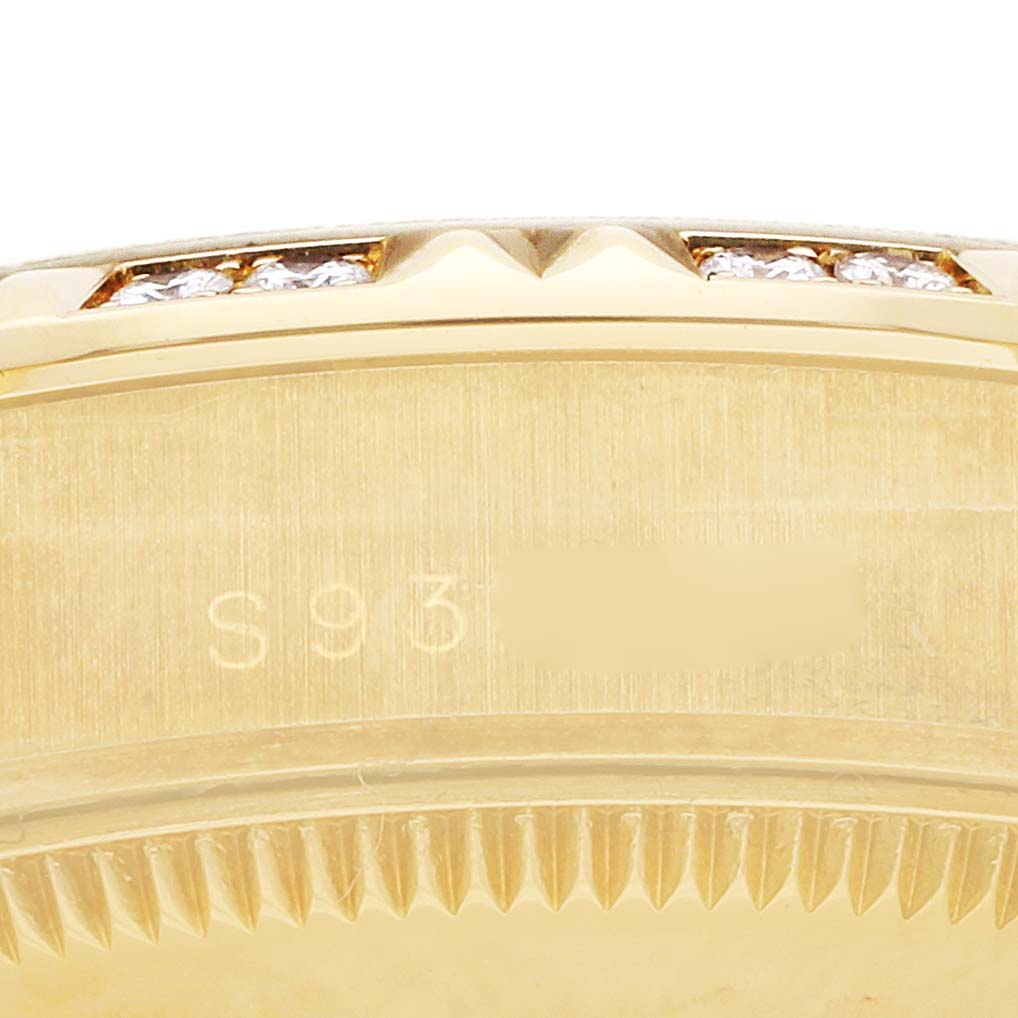 The image shows an angled close-up of a gold Mid-Size Rolex watch case and bezel with diamonds.