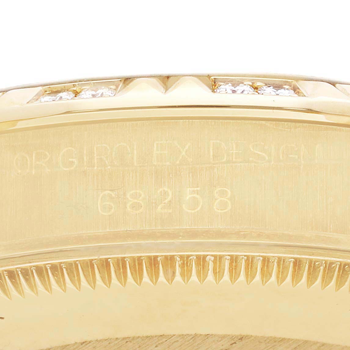 The image shows the side view of the bezel and part of the case of a Rolex Mid-Size model, highlighting the model number engraving.