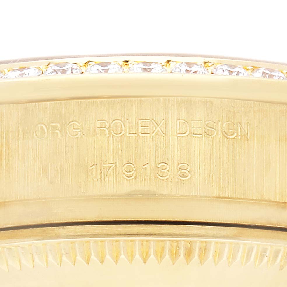 The image shows a close-up of the side of the Rolex President 179138 Women's Yellow Gold Mother of Pearl Dial 179138 Women's Yellow Gold Mother of Pearl Dial model, highlighting the engraved markings and bezel.