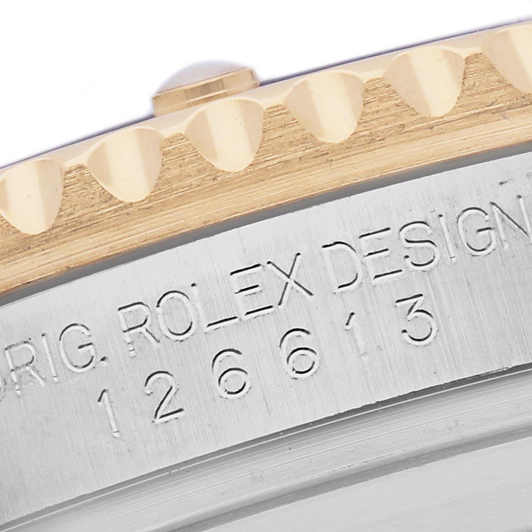 The image shows a close-up angle of the Rolex Submariner 126613LB Men's Steel and Gold (two tone) Blue Dial 126613LB Men's Steel and Gold (two tone) Blue Dial model's bezel and engraved side, featuring the model number.